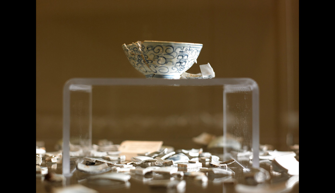 Partially reconstructed Double Happiness rice bowl surrounded by shards of Bamboo rice bowls. The names "Double Happiness" and "Bamboo" refer to the very popular painted motifs painted on the bowl.